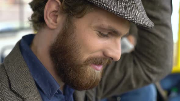 Close up of Man with Beard Playing on Tablet in Bus