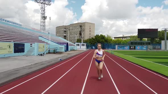 Top View of a Young Woman Running in the Stadium