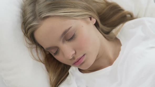 Cute Girl Sleeping Comfortably on Soft Bed Linens, Calm and Quiet Dream Top View