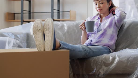 Woman Moving to New Home and Drinking Coffee