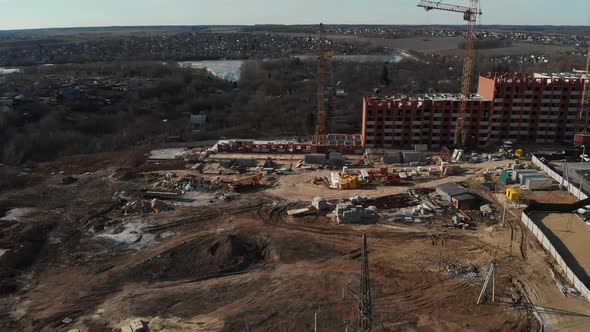 The Camera Flies Up To the Construction Site on the Outskirts of the City. Aerial View 