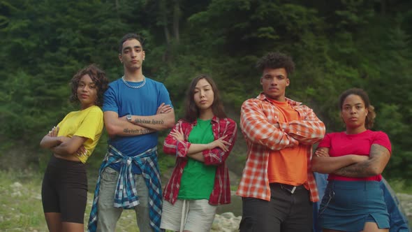 Confident Attractive Diverse Multiracial Backpacker with Arms Crossed Posing at Campsite