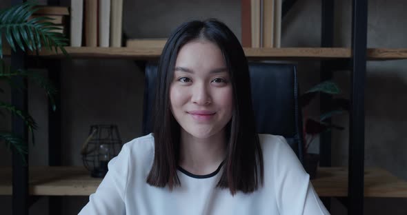 Closeup Video Portrait of Friendly Cute Successful Confident Young Brunette Asian Woman Office