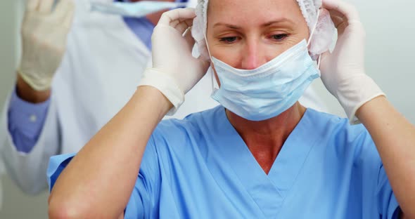 Dentist and dental assistant wearing surgical mask