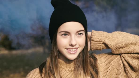 Portrait of Smart Girl Smiling to the Sunny Sky in Park Using Colourful Fires