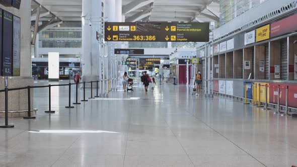 Young Couple in an Airport During the Pandemic Season Both Wearing Masks