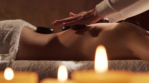 Young, healthy and beautiful woman gets massage therapy in the spa salon.