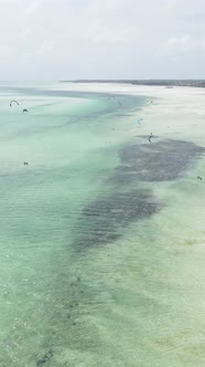 Vertical Video Kitesurfing Near the Shore of Zanzibar Tanzania