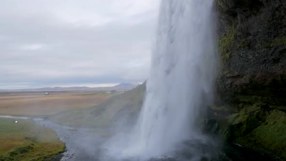 Slow Motion Shot from Behind Seljalandsfoss Waterfall.