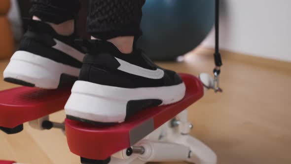 Close Up Womans Feet in Sneakers Training on the Twist Stepper with Digital Display and Gum