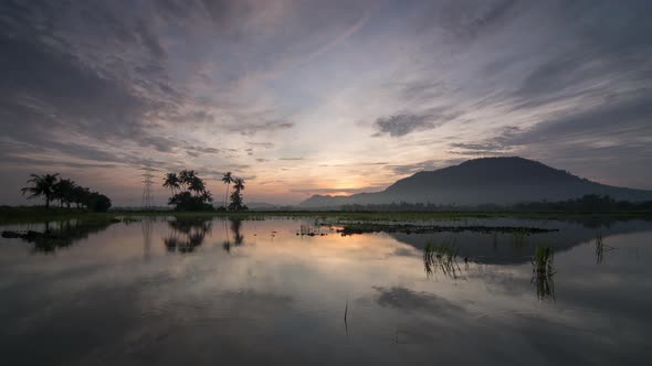 Timelapse panning from left to right with colorful sunrise cloud