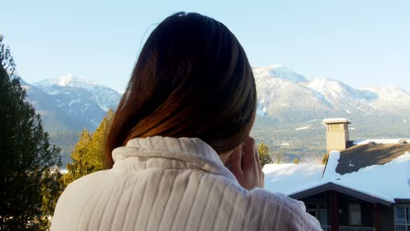 Woman having coffee in balcony