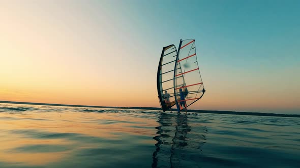 Two Men Are Standing on Sailing Windsurf Boards