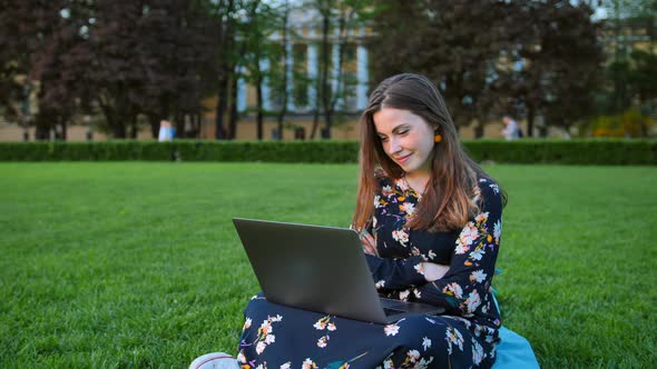 Young Attractive Handsome Woman Using Laptop in the Outdoor Park.