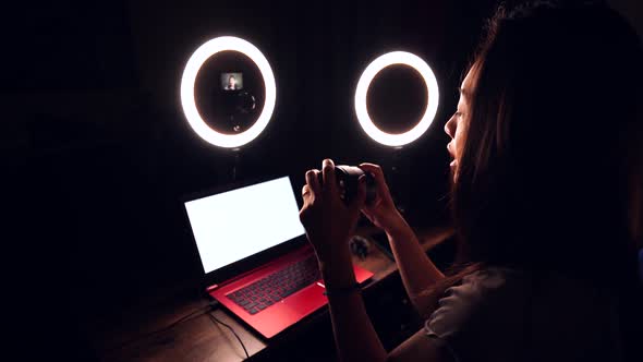 Female blogger showing camera lens