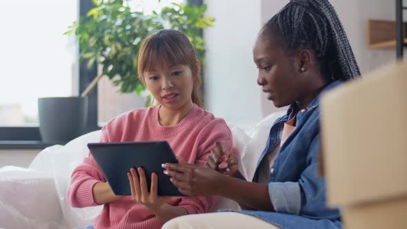 Women with Tablet Pc Moving to New Home