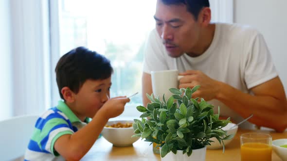 Father and son having breakfast
