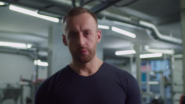 Athletic Build Man Eating Protein Bar After Workout