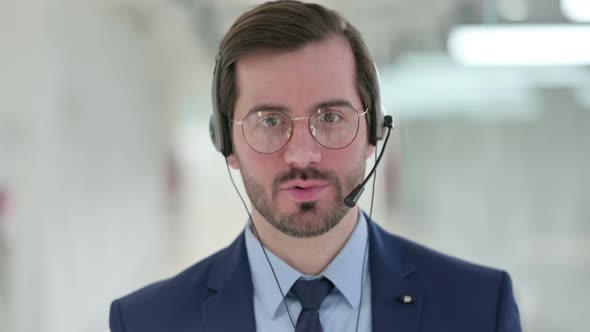 Professional Young Businessman Talking on Headset