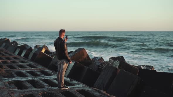 Man Walks on a Stone Beach