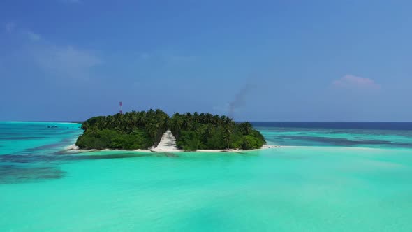 Aerial above travel of idyllic coastline beach voyage by blue water with white sandy background of a