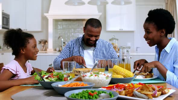 Family having meal on dinning table at home