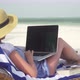 Young Woman Uses Laptop On White Beach Near Ocean - VideoHive Item for Sale
