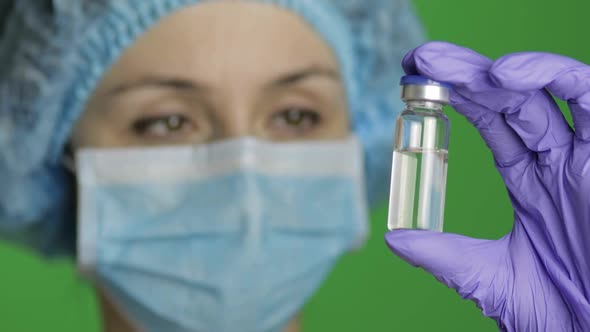 Female Scientist Holding Ampoule in Hand, New Medication Developing, Vaccination