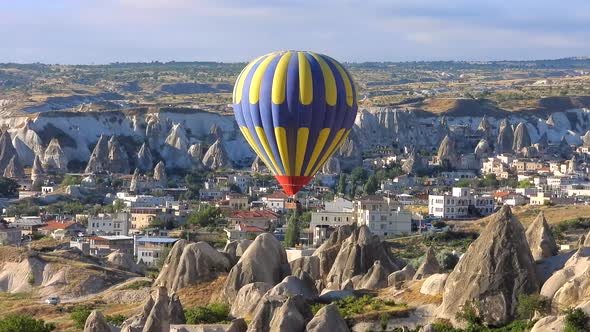 Hot Air Balloon Flying Over Hoodoos and Fairy Chimneys in Goreme Valley Cappadocia, Urgup Turkey