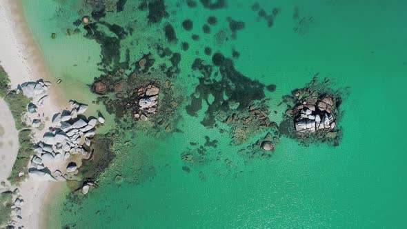 Aerial Top Down View of Huge Rocks in the Sea Turquoise Water and the Beach