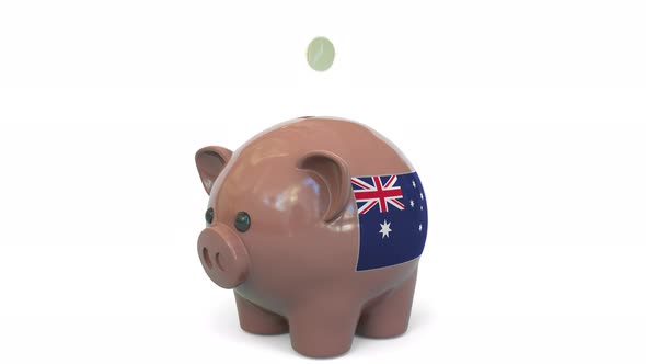 Putting Money Into Piggy Bank with Flag of Australia