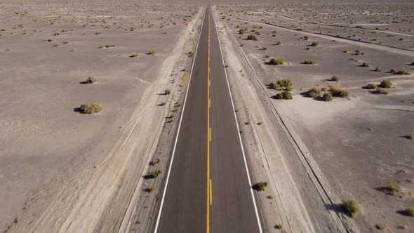 Aerial shot of a remote desert road with no cars in Nevada