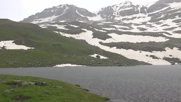 Hail on the Mountain Lake in High Altitude Meadow