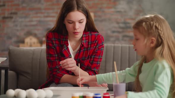 Attentive Elder Sister Helps Little Girl Draw Marbling