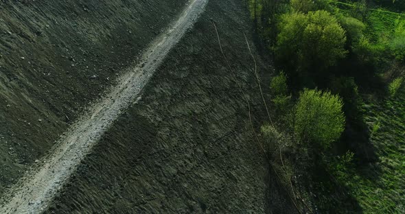 Aerial view of the side of a hill made of garbage dump.