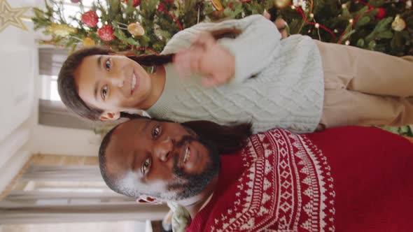 Cheerful Black Dad and Daughter Video Calling on Christmas