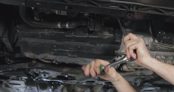 Mechanic Change Oil Filter Of Modern Car