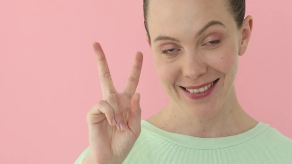 Smiling Happy Woman Showing Victory Sign