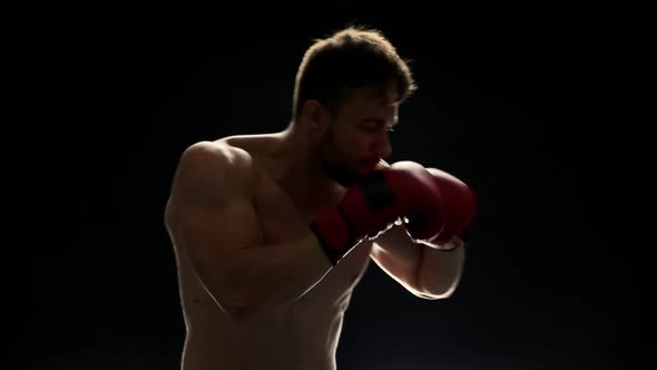 Young Boxing Fighter on Black.