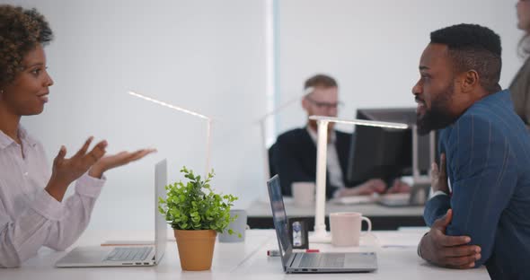 Side View of Young Confident Business People Talking in Modern Open Space Office