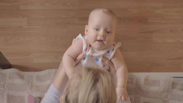 Mother Playing with Her Newborn Daughter