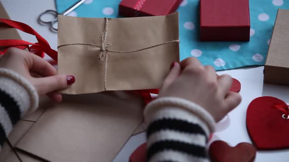 Female preparing for wrapping gifts on Valentine Day