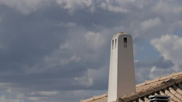 Time lapse Traditional algarve chimney with cloudsing fast