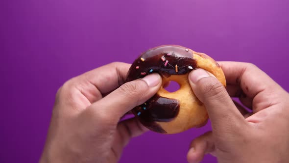 Close Up of Man Hand Eating Donuts