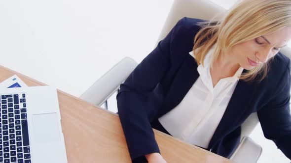 Businesswoman working over laptop at her desk