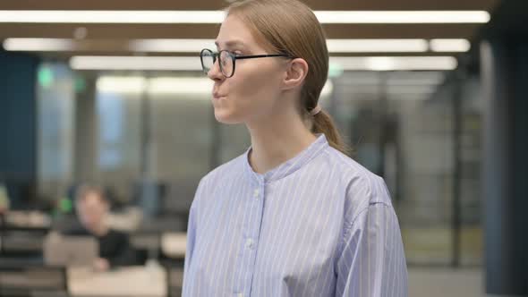 Portrait of Young Woman Waiting and Checking Watch