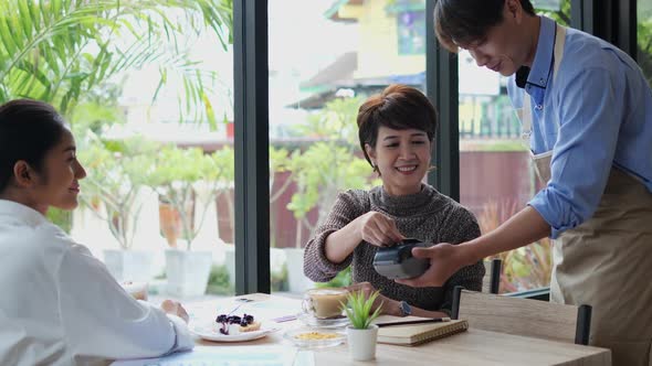 Woman payment in coffee cafe