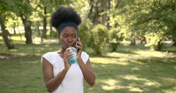 African Girl with Drink Talk By Phone