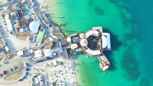 Aerial view of people partying in club on the sea water, Pag island