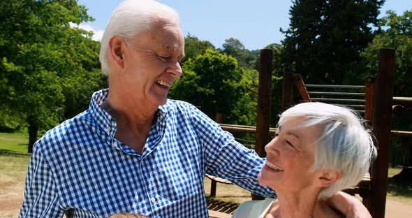 Senior couple interacting with each other in park